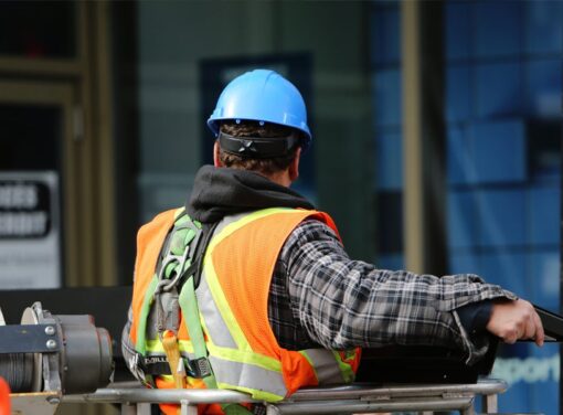 View of a construction workers back as they operate a lift