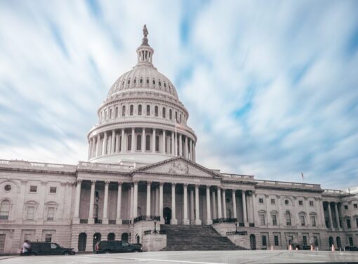 Front facade of U.S. Captiol buidling with blue sky in background