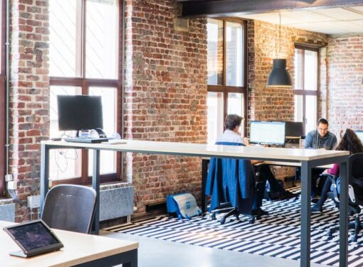 Modern office setting with colleagues working around large desk