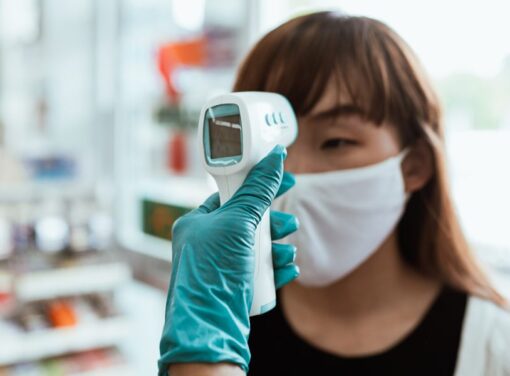 Business employee getting their temperature checked before work