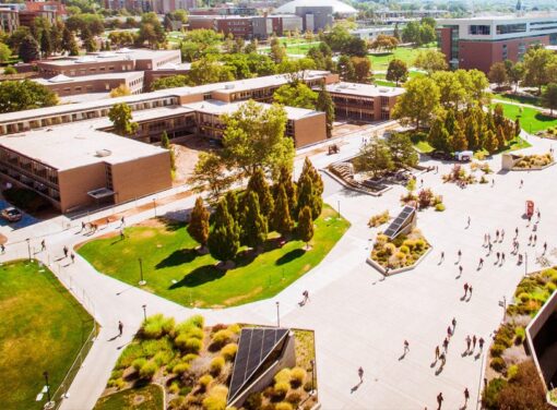 Aerial view of college campus buildings and people walking around