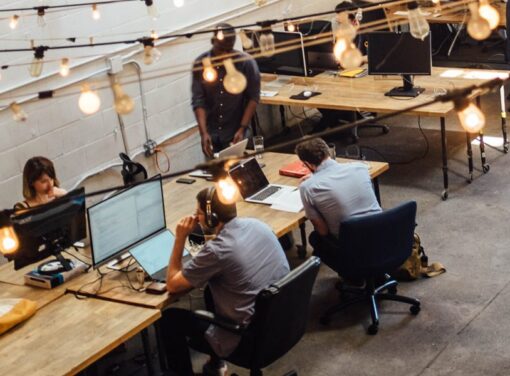 Modern office setting with colleagues working around large desk