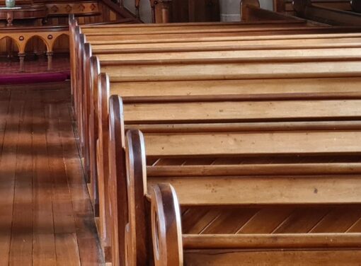 Row of empty wooden church pews