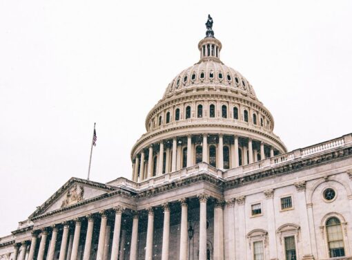 U.S. capitol building facade in the winter with snow falling