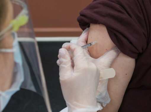 Healthcare working giving citizen a COVID-19 vaccine shot
