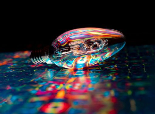 Light bulb lit up with random colors