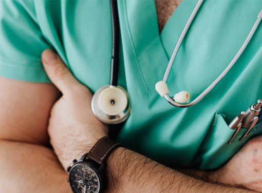 Closeup on healthcare worker uniform, arms crossed
