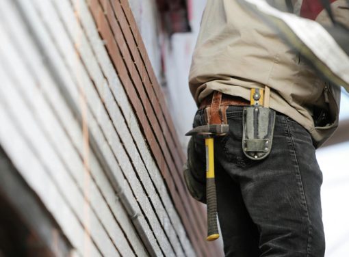 contractor with hammer and tool belt