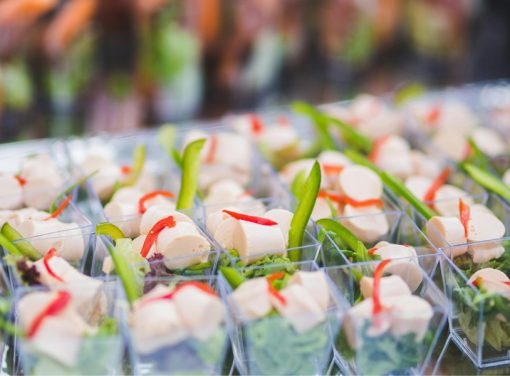 Catering table with cups of food