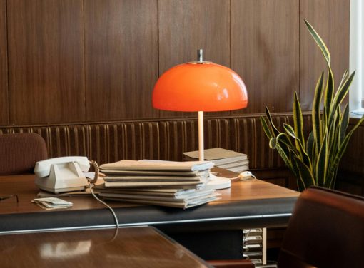 Desk with papers, phone, orange table light