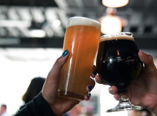 Two people cheers beer