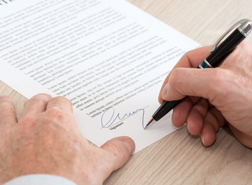 man signing a contract