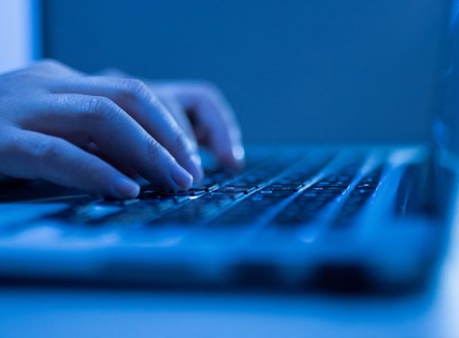 Someone typing on computer