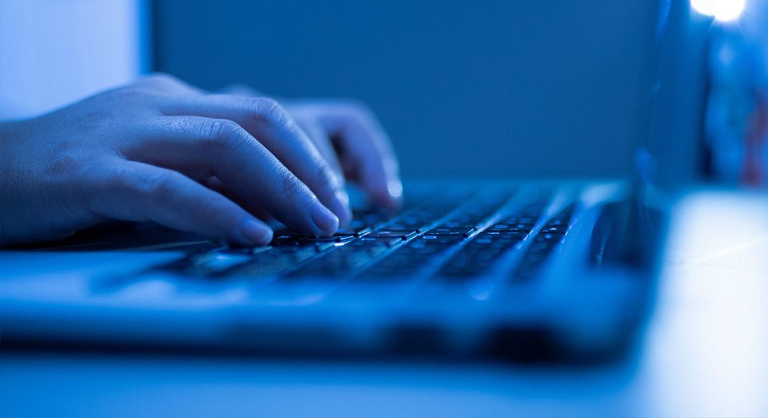 Someone typing on computer