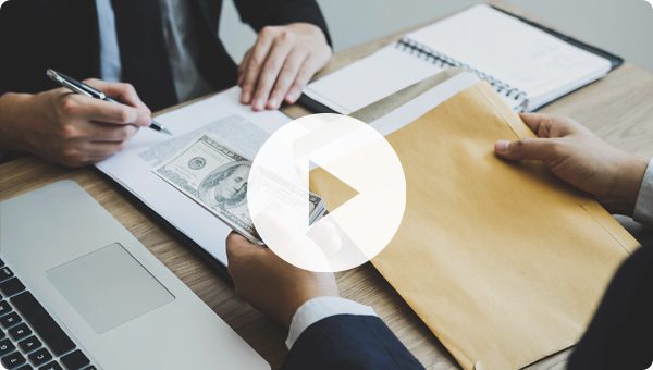Business professionals exchanging money in meeting