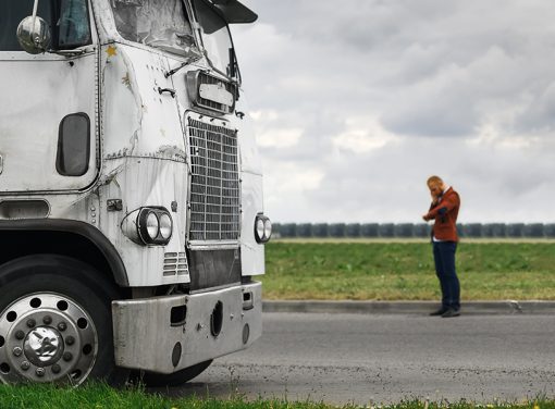 trucker making a phone call next to truck
