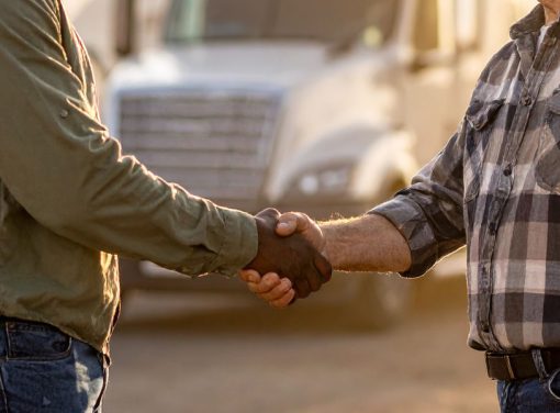 Two Truck Drivers Shaking Hands