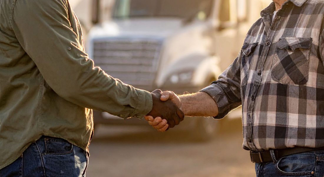 Two Truck Drivers Shaking Hands