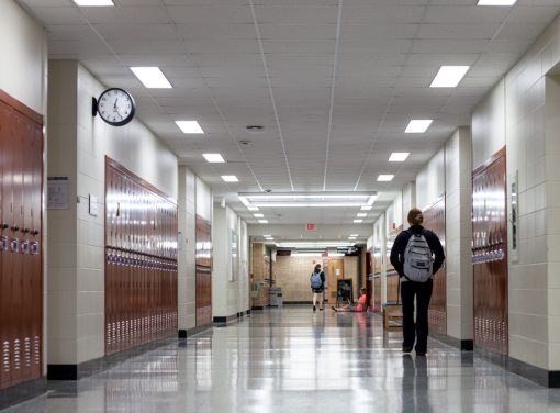 High school student walks down hallway