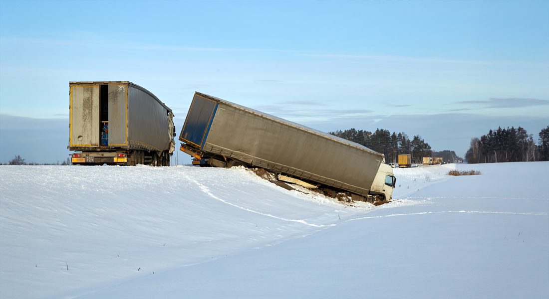Trucking accident on snowy road.