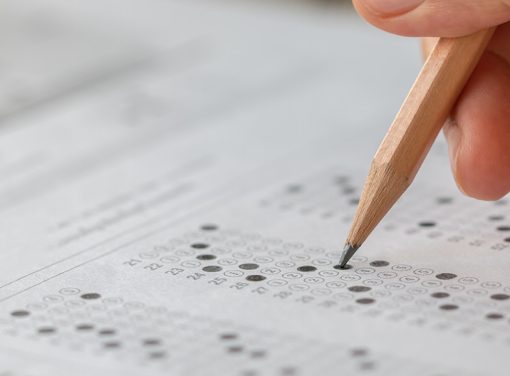 hand filling in survey with pencil