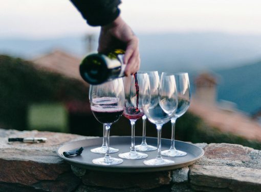 Hand pouring wine in glasses at funeral event