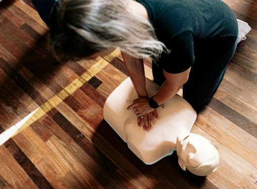 Woman practicing CPR on dummy
