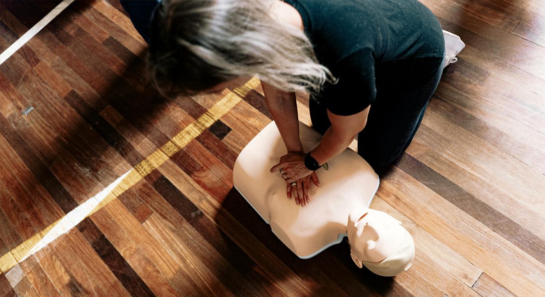 Woman practicing CPR on dummy