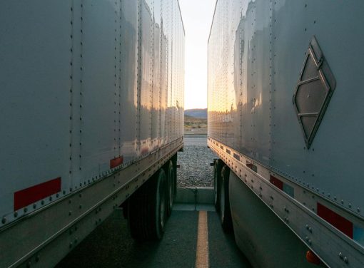 Two semi trucks parked next to each other